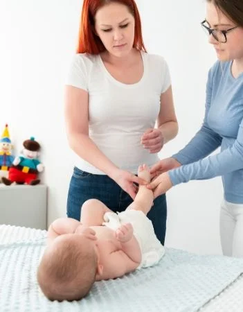 Mother and doctor checking infant development