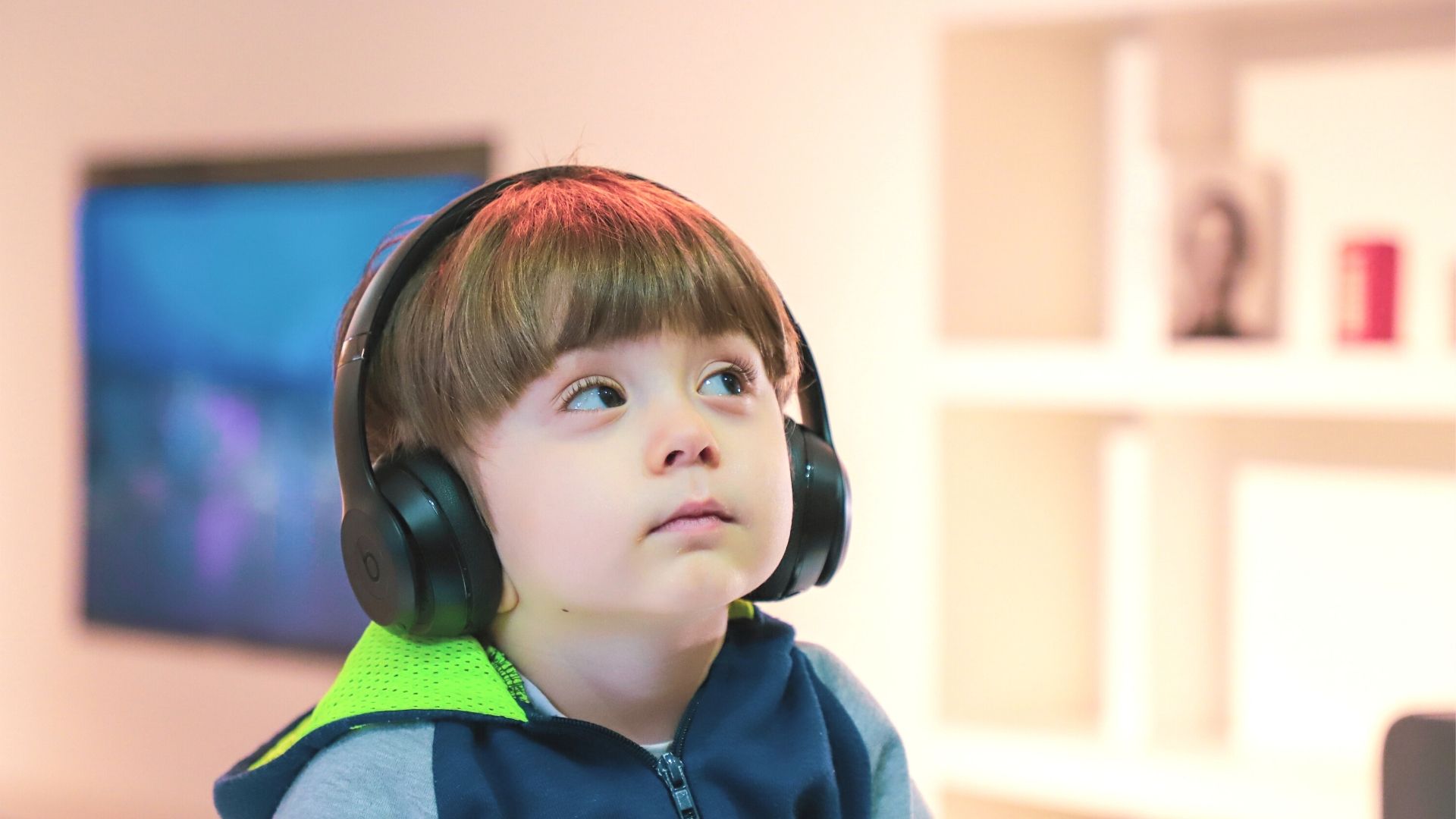 Young boy sitting with black headphones