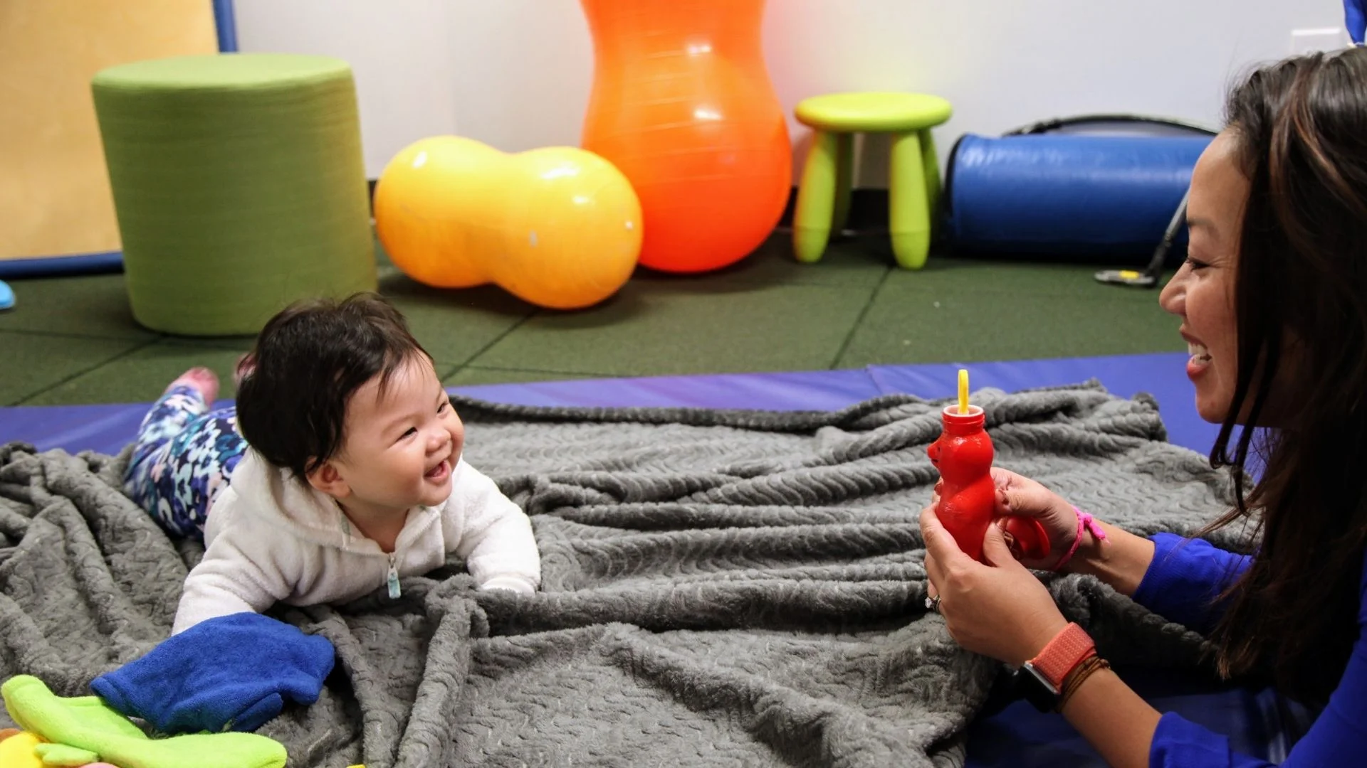 Image: Mother playing on the floor with baby