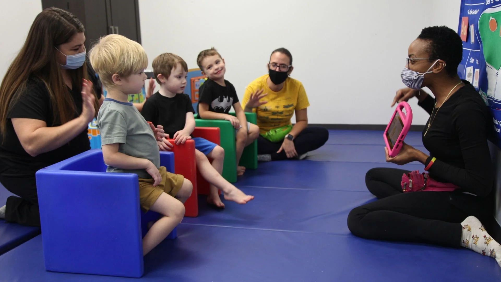 image: Group of preschool aged children playing in a circle